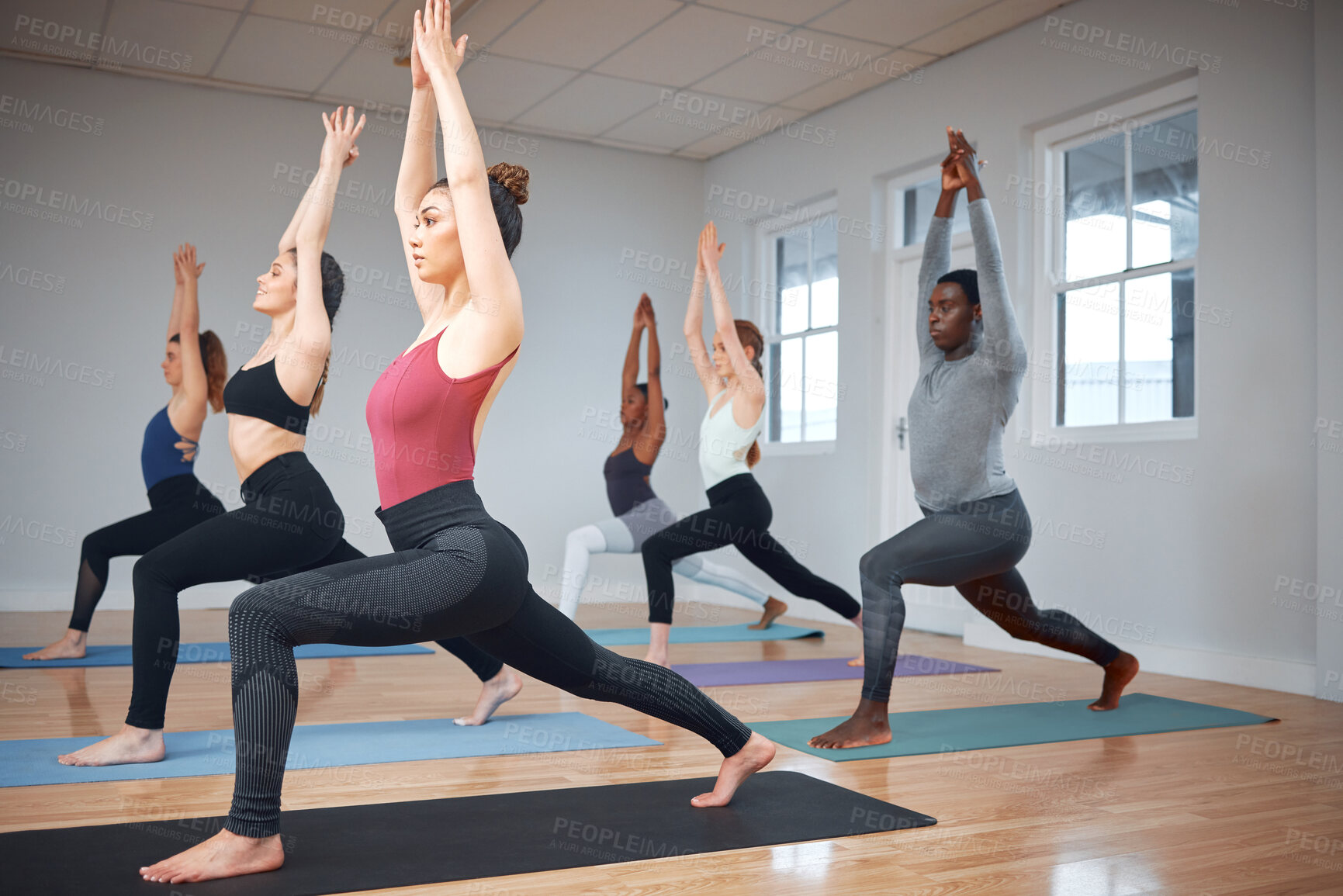 Buy stock photo Exercise, class and warrior pose for workout at gym, spiritual awareness and together for pilates training. People, strong lunge and community fitness in studio, yoga challenge and stretching muscle