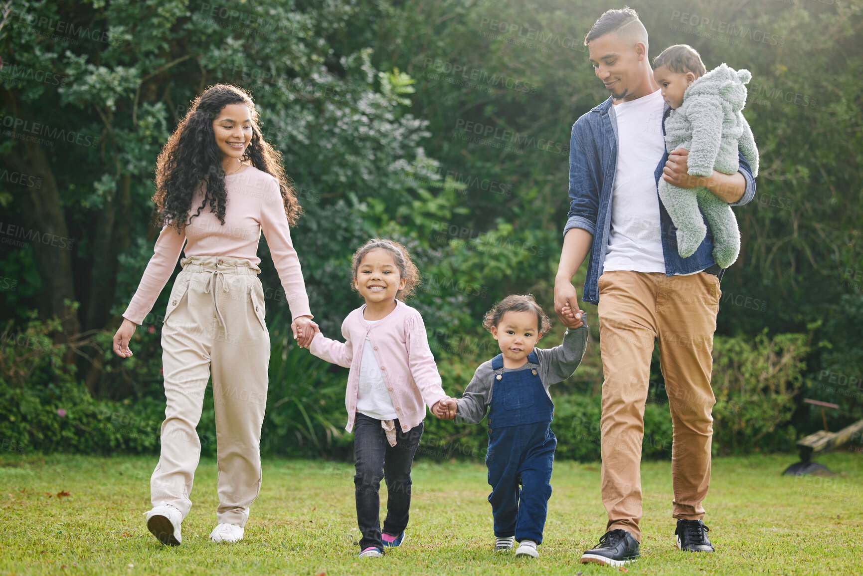 Buy stock photo Family, garden and walk with holding hands of parents and children with love, support and care outdoor. Lawn, backyard and nature with baby, mom and dad together with bonding and weekend activity