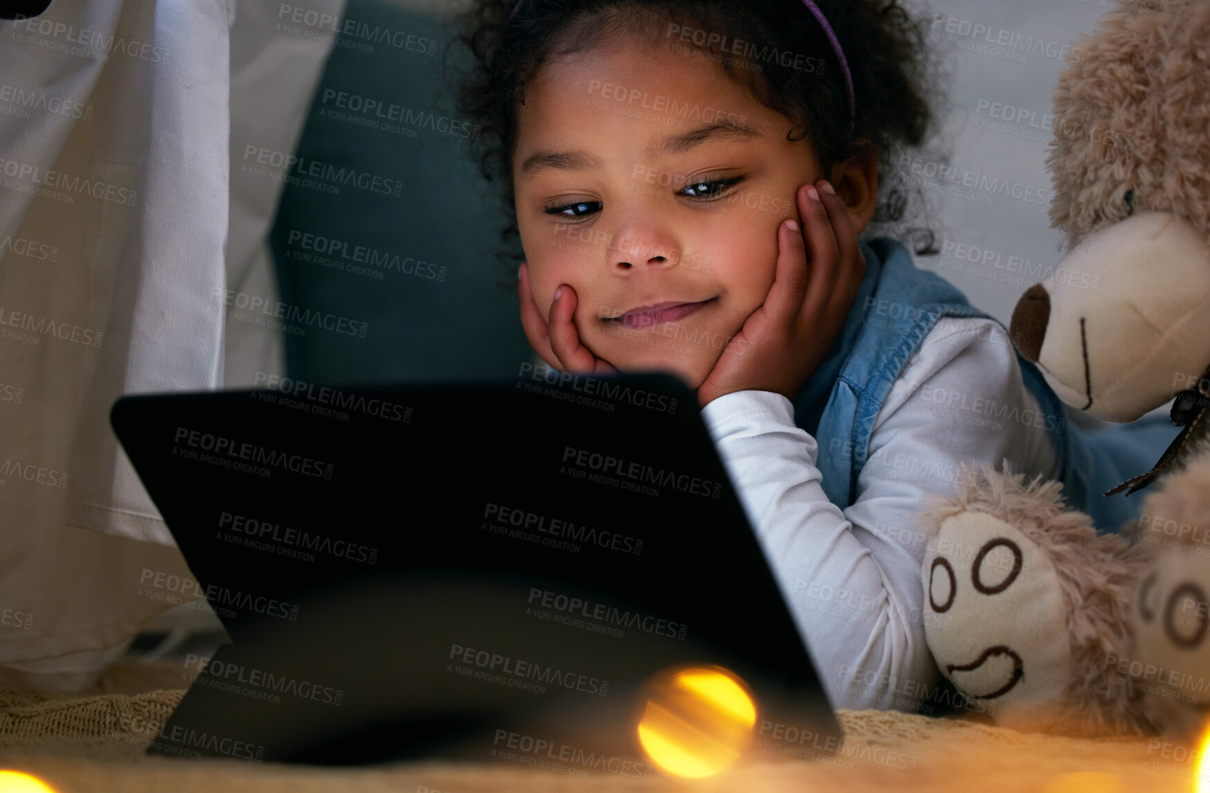 Buy stock photo Girl, child and tablet for watching movie at night in home, fort and teddy bear for friendship. Female person, kid and online subscription for streaming cartoon series, internet video and relax