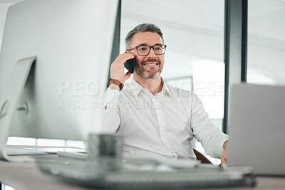 Buy stock photo Shot of a mature businessman sitting alone in his office and using his cellphone