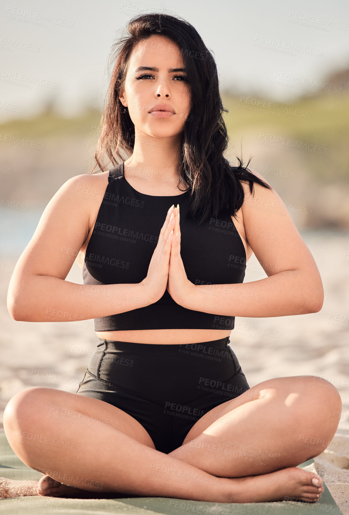 Buy stock photo Portrait of an attractive young woman meditating at the beach