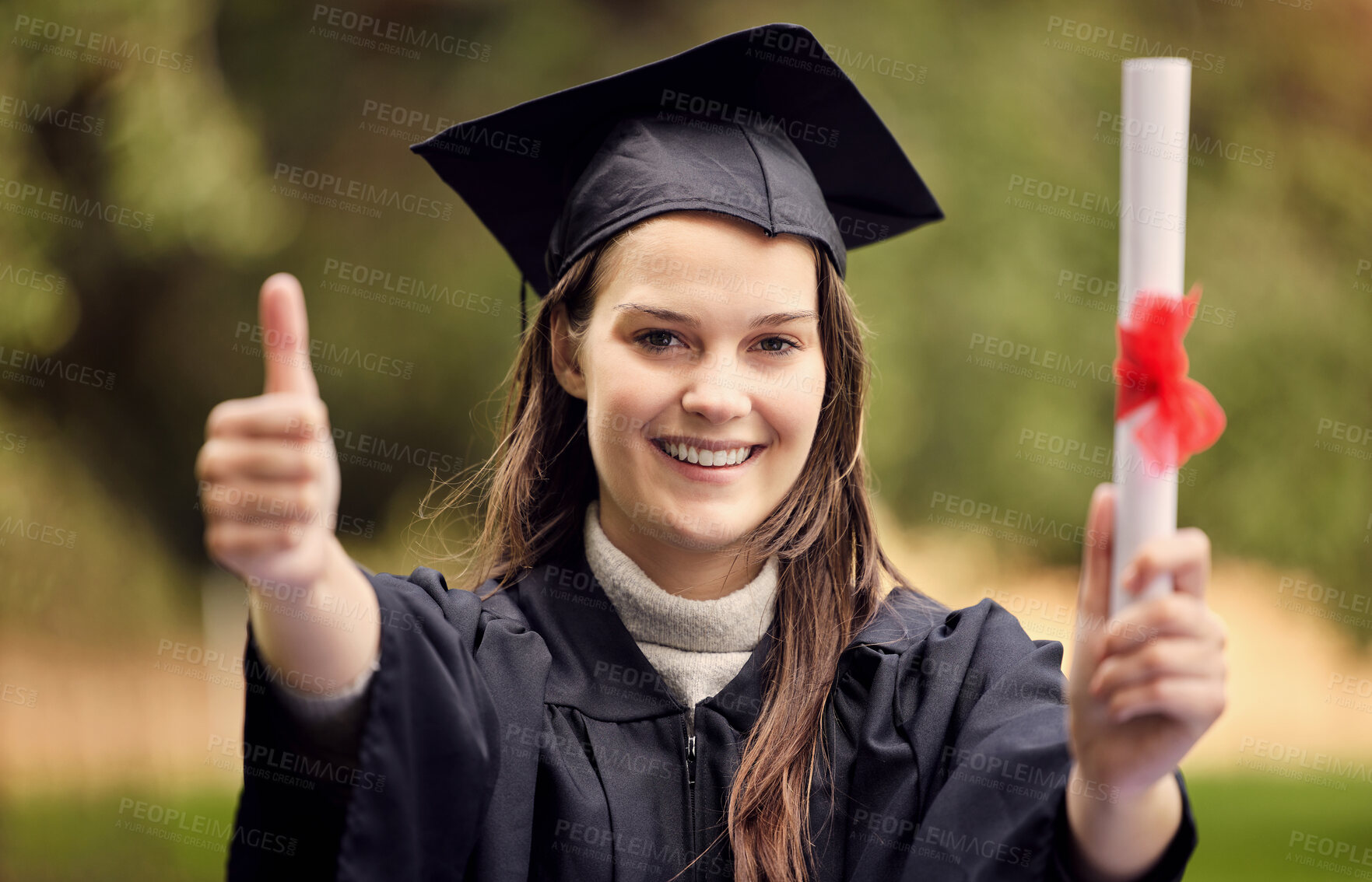 Buy stock photo Graduation, thumbs up and portrait of woman at university for education, diploma or success ceremony. Student, hand gesture and person with certificate for achievement, satisfaction or happiness