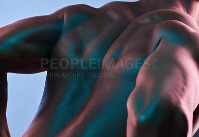 Buy stock photo Shot of a muscular man posing against a studio background