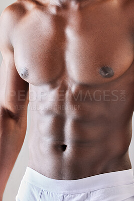 Buy stock photo Stomach muscle, abs and closeup of man, health and wellness with aesthetic beauty in studio. Body care, motivation and zoom of topless abdomen of African fitness model or bodybuilder in underwear.