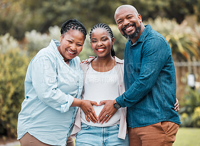 Buy stock photo Shot of a mother and father celebrating their daughter's pregnancy
