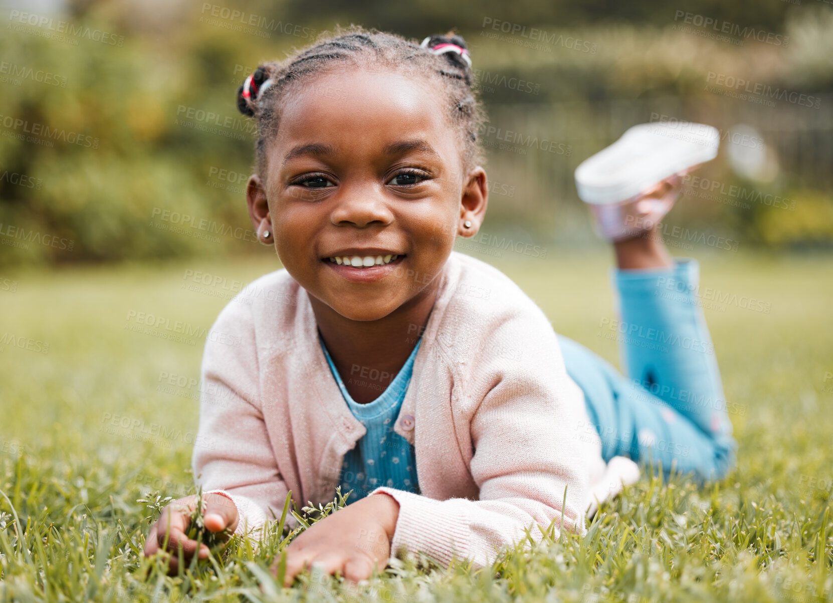 Buy stock photo African girl, child and lying on lawn for portrait, smile and relax on vacation, picnic and outdoor in nature. Kid, happy and excited on grass in backyard, summer and playful for development in Kenya