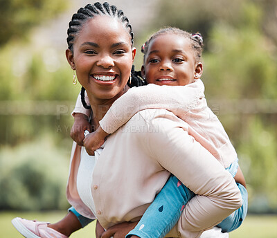 Buy stock photo Shot of a woman giving her daughter a piggyback ride
