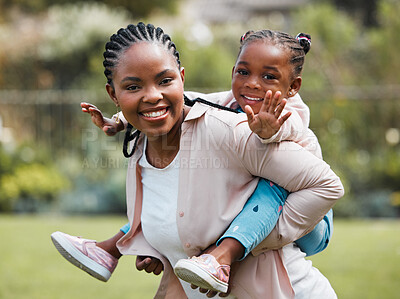 Buy stock photo Shot of a woman giving her daughter a piggyback ride