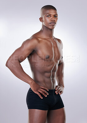 Buy stock photo Handsome, shirtless and portrait of a man in a studio with a muscular body in underwear. Serious, fitness and young African male model with a strong, sexy and attractive figure by white background.