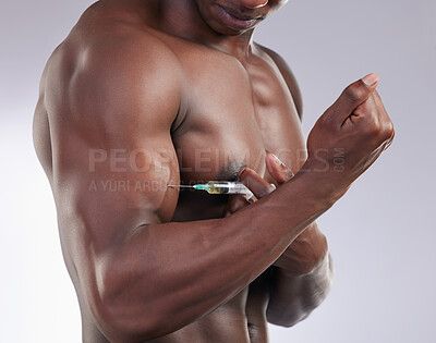 Buy stock photo Cropped shot of an unrecognisable man standing alone in the studio and taking steroids
