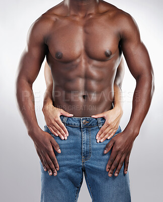 Buy stock photo Cropped shot of an unrecognisable man standing and posing shirtless while his girlfriend touches him