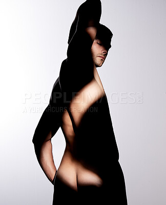 Buy stock photo Shot of a muscular young man posing against a studio background