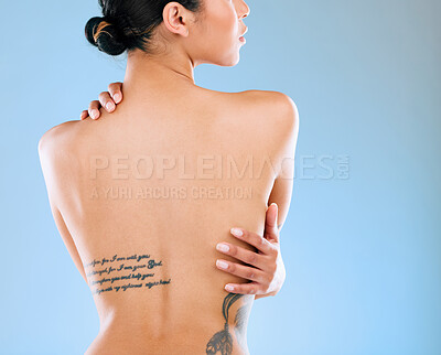 Buy stock photo Rearview shot of a young woman posing against a blue background