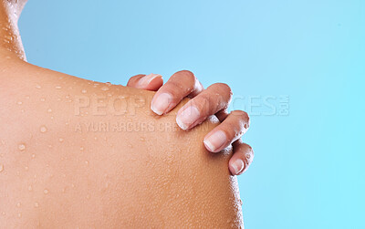 Buy stock photo Studio shot of an unrecognizable young woman showering against a blue background