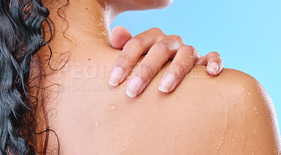 Buy stock photo Studio shot of an unrecognizable young woman showering against a blue background