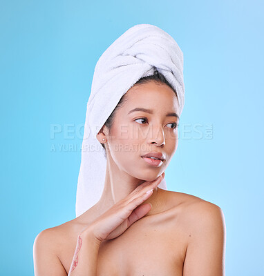 Buy stock photo Studio shot of an attractive young woman posing with a towel on her head against a blue background