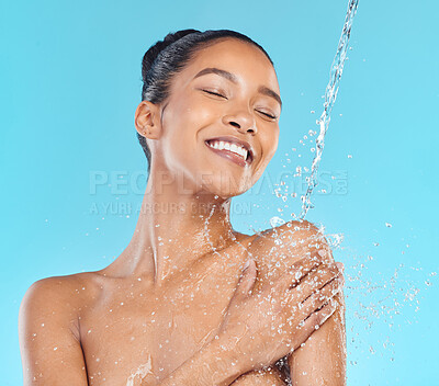 Buy stock photo Shot of an attractive young woman showering against a blue background