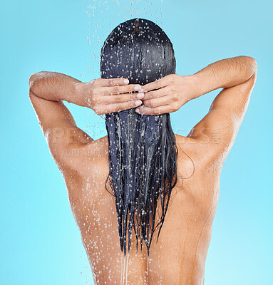 Buy stock photo Shot of a unrecognizable woman showering against a blue background