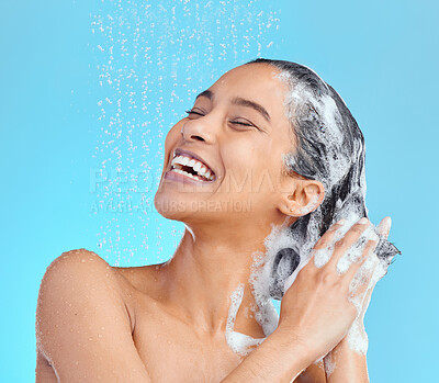 Buy stock photo Shot of an attractive young woman showering against a blue background