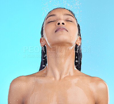 Buy stock photo Shower, woman and hair in studio for cleaning, wellness and grooming on blue background. Shower, hair care and black woman relax in water splash, beauty and skincare, hygiene and standing isolated