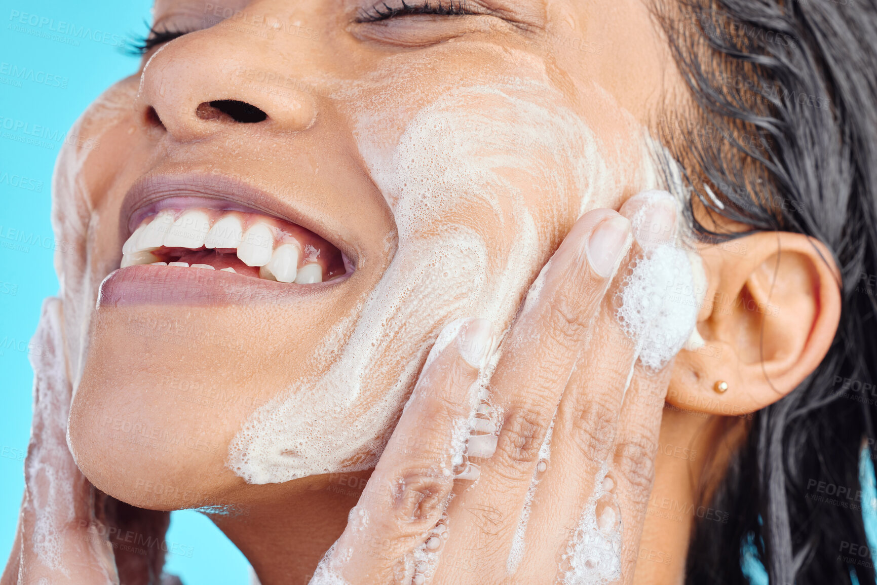 Buy stock photo Shower soap, happy face and black woman cleaning body with liquid for hydration, beauty healthcare or skincare hygiene. Self care studio, spa foam and relax model washing isolated on blue background