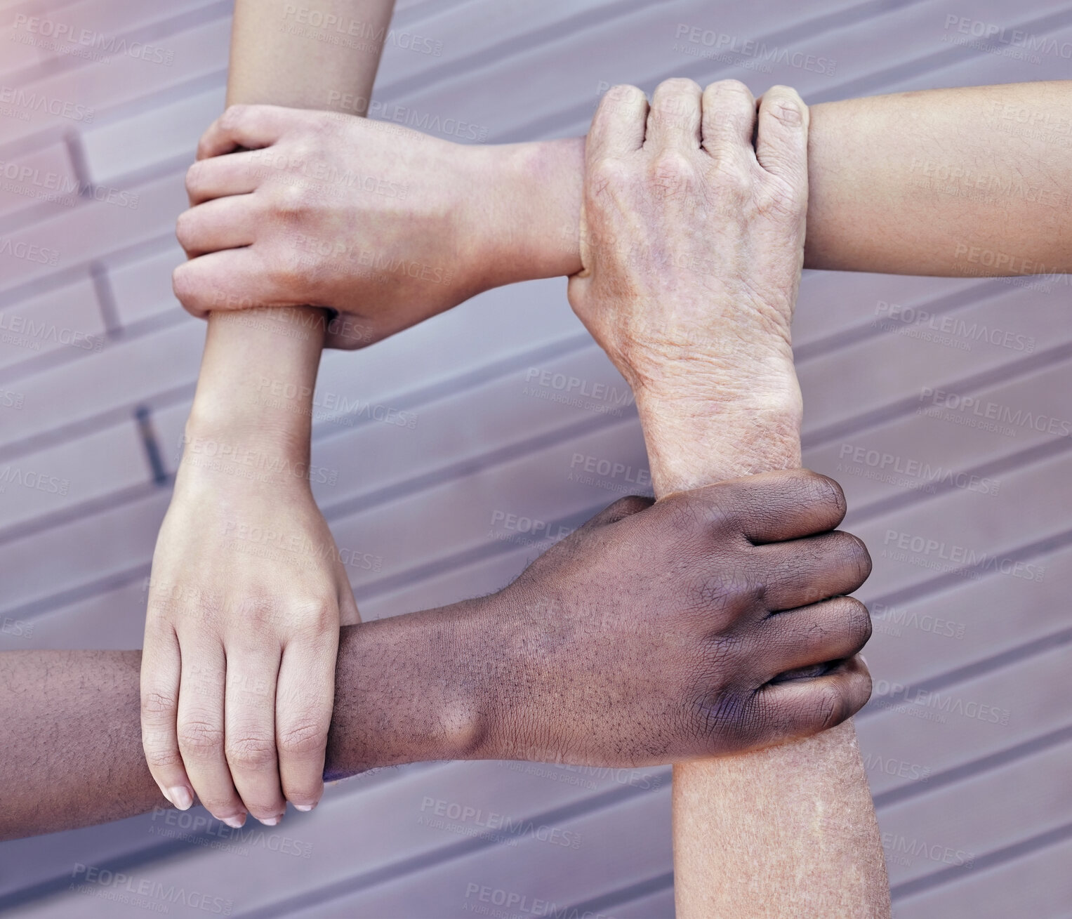 Buy stock photo Cropped shot of a group of unrecognizable businesspeople linking arms