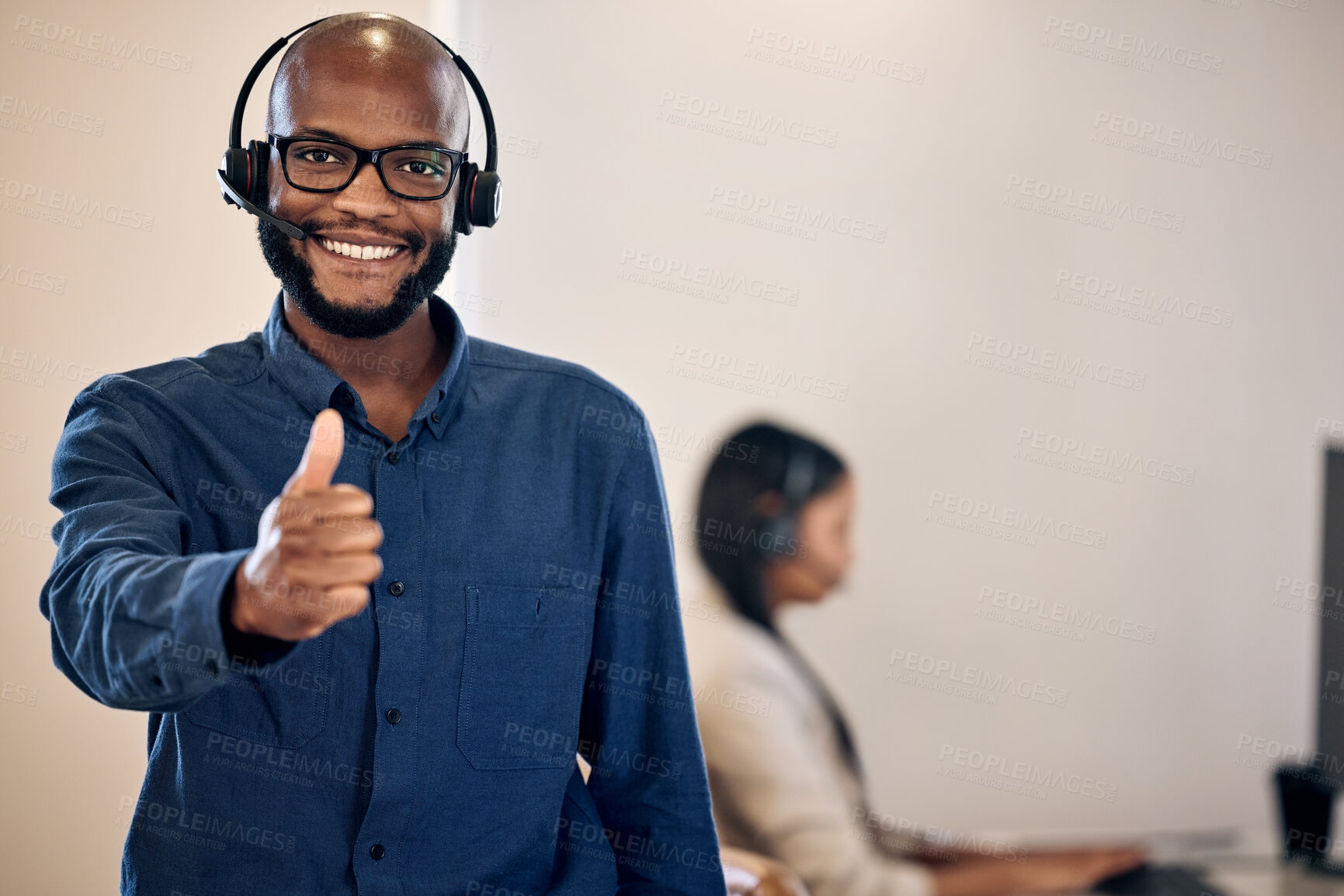 Buy stock photo Call center, thumbs up and a man smile for customer service, crm or telemarketing support. Black person, consultant or agent with headset and yes emoji or hand sign for sales, contact us or help desk