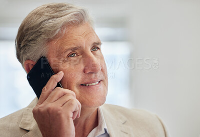 Buy stock photo Shot of a mature businessman standing in the office and using his cellphone