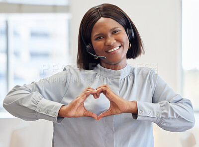 Buy stock photo Shot of an attractive customer service agent standing alone in the office and showing a heart shaped hand gesture