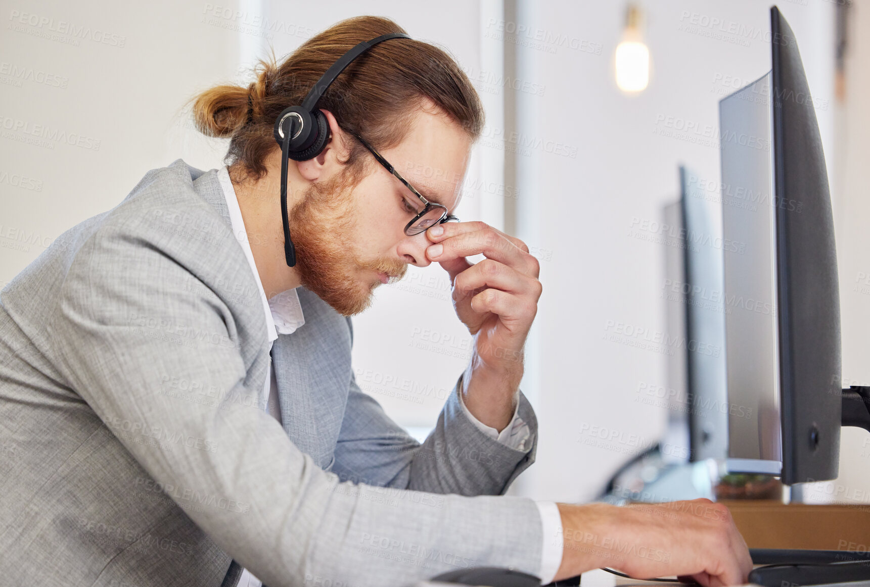 Buy stock photo Call center, man and agent with headache by computer with fatigue, tired and overworked at telemarketing job. Person, consultant and pain with stress, exhausted and burnout by pc for customer care