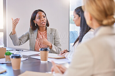 Buy stock photo Shot of a young businesswoman having a meeting with her colleagues in an office