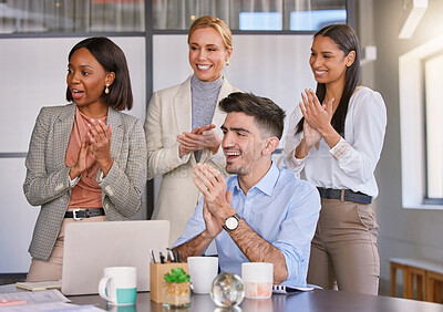 Buy stock photo Shot of a group of businesspeople applauding together in an office