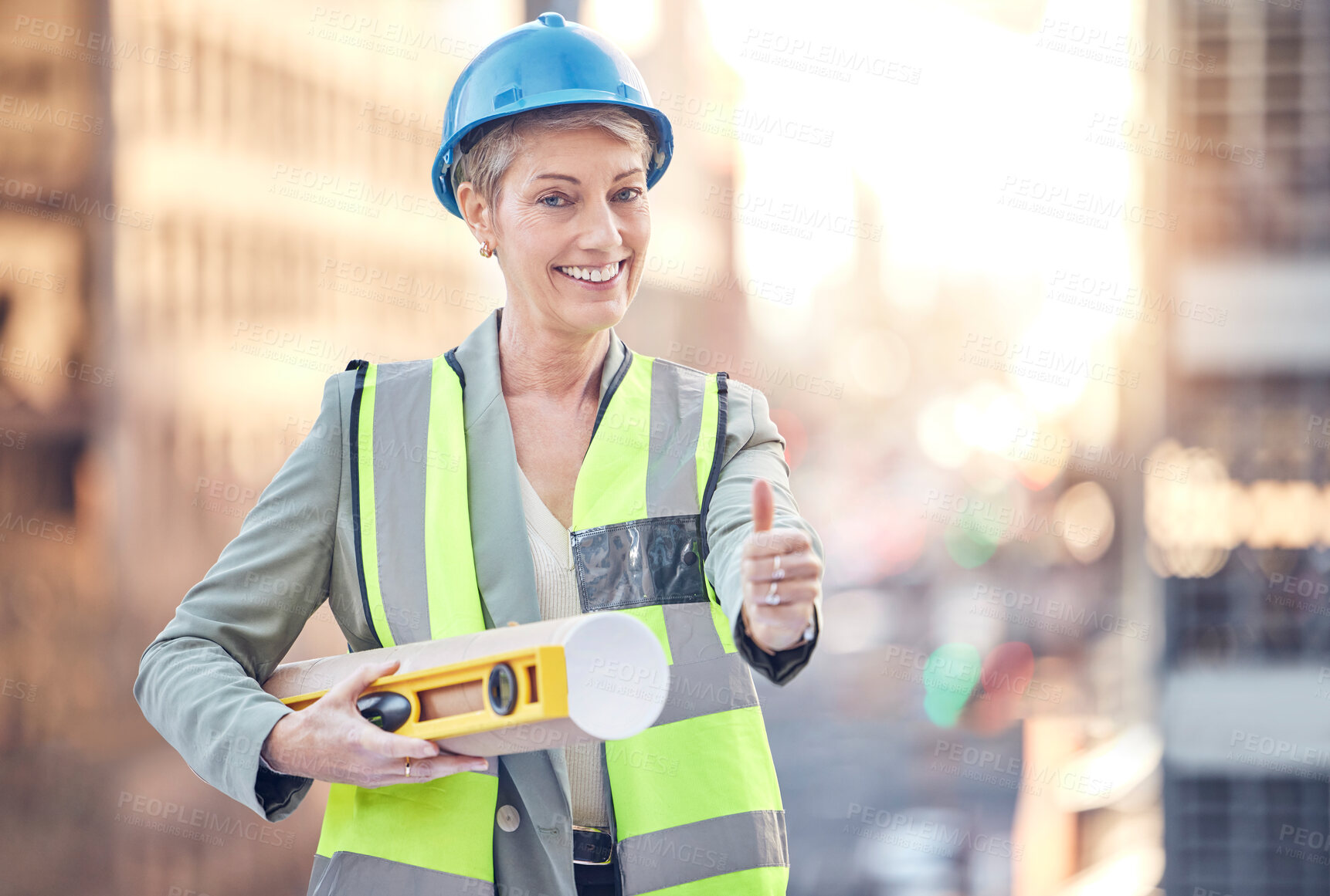 Buy stock photo Construction worker, woman and thumbs up for portrait with smile for vote, choice or good service. Mature architect, metro building and like sign with blueprint, property and real estate development