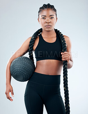 Buy stock photo Portrait, female person and medicine ball for health, fitness and exercise in white background with battle rope. African, woman and ready for workout, training or cardio as athlete in studio backdrop