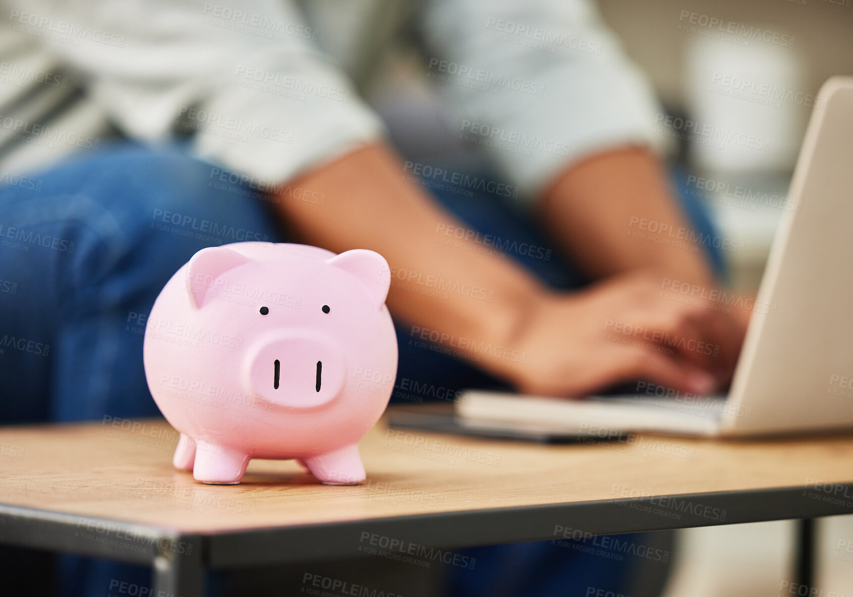 Buy stock photo Shot of a piggy bank on a table  in a house