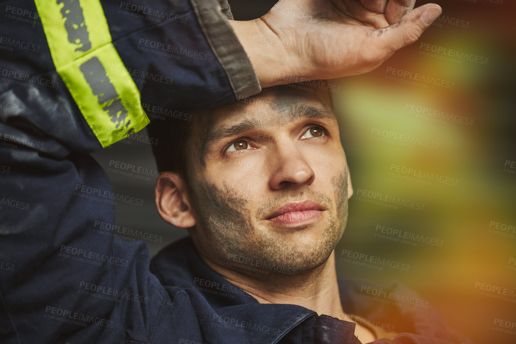 Buy stock photo Shot of a handsome young male firefighter planning his next move