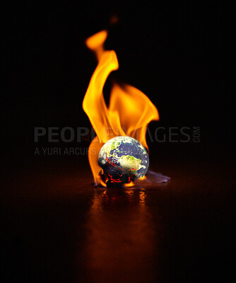 Buy stock photo Shot of the earth engulfed in flames against a black background