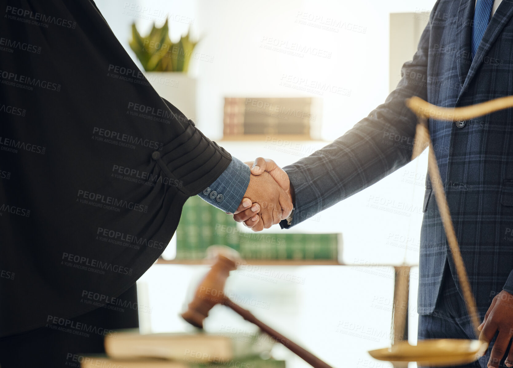 Buy stock photo Shot of two unrecognizable lawyers shaking hands at work