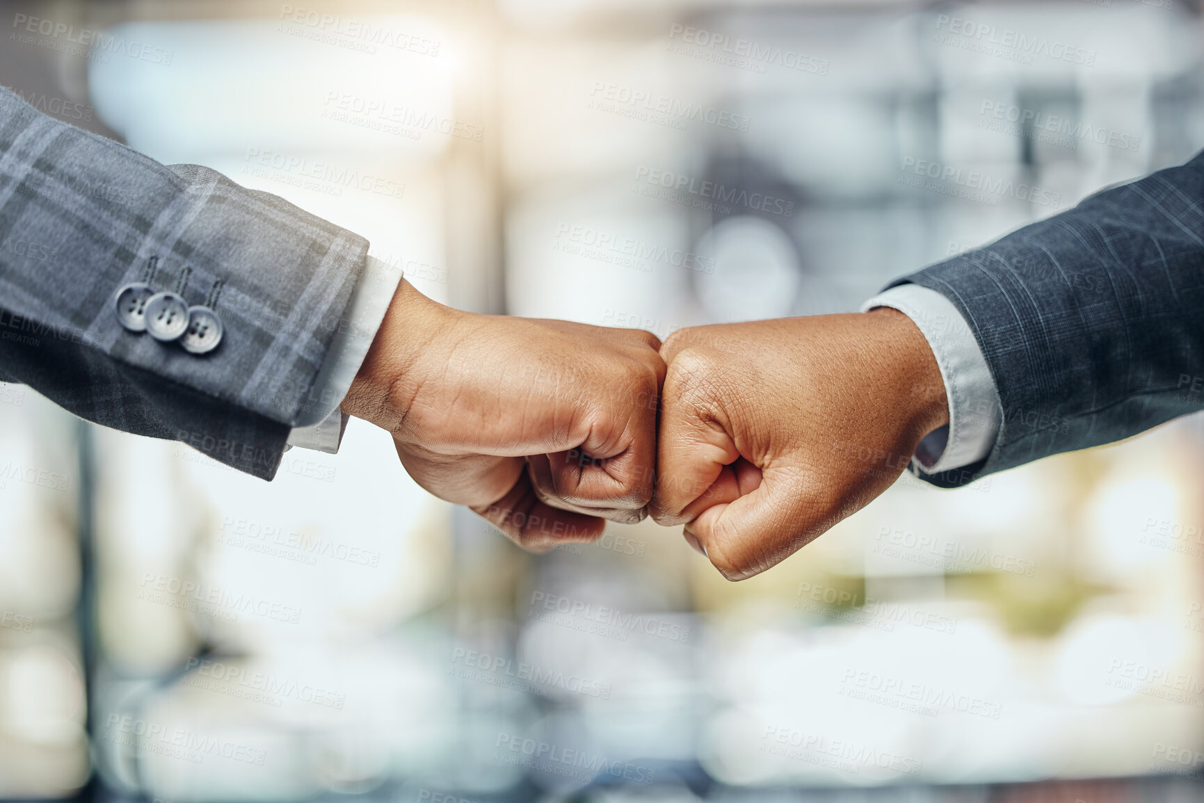 Buy stock photo Shot of two unrecognizable lawyers giving each other a fist bump at work