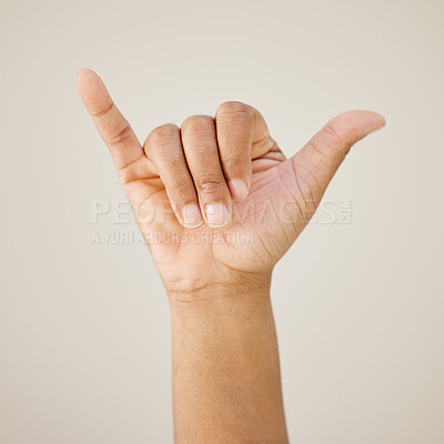 Buy stock photo Person, hand gesture and sign language in studio background, shaka icon and surfing culture of call me. Telephone, signal and carefree emoji for connection, greeting and interactive symbol of contact