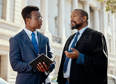 Buy stock photo Shot of two lawyers talking in the city