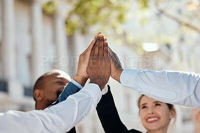 Buy stock photo Shot of a group of businesspeople giving each other a high five in the city