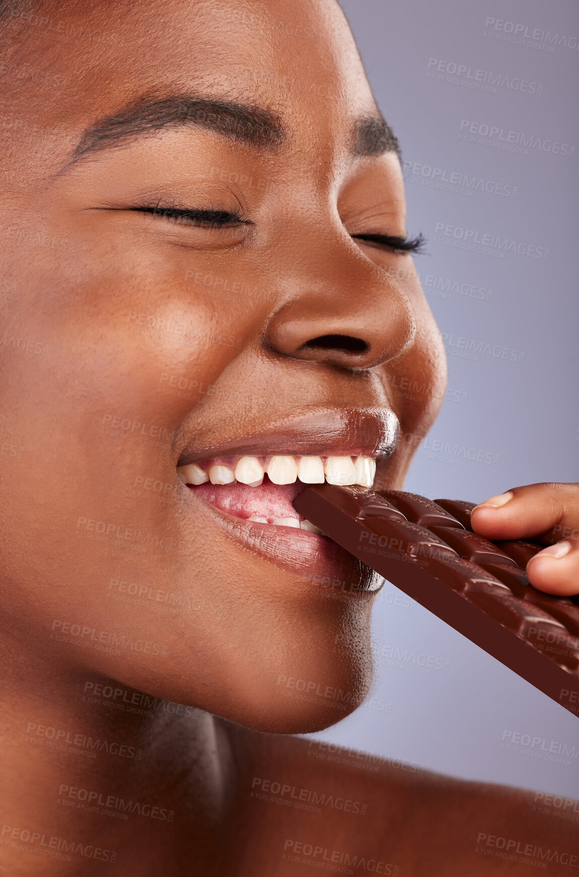 Buy stock photo Chocolate, black woman and eating in studio with eyes closed for unhealthy diet, sugar or cheat day on gray background. Closeup, bite and model for snack temptation, sweet addiction or cacao bar