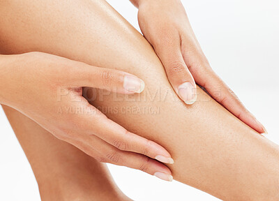 Buy stock photo Woman, legs and hands for skincare in studio for glow on white background for self care and wellness. Female person, body treatment and shave or hair removal for grooming, hygiene and waxing for skin