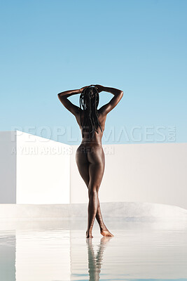 Buy stock photo Rearview shot of an unrecognizable young woman posing nude outdoors