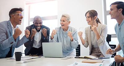 Buy stock photo Shot of a group of businesspeople cheering while working on a laptop together in an office