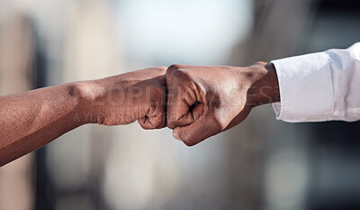 Buy stock photo Cropped shot of two unrecognizable businessmen fist bumping outside