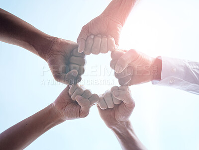 Buy stock photo Cropped shot of a group of unrecognizable businesspeople joining their fists together