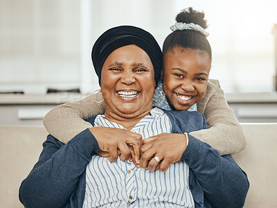 Buy stock photo Shot of a grandmother bonding with her granddaughter on a sofa at home