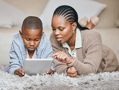 Buy stock photo Mother, child and tablet at house for streaming, education games and watch video of learning support. Black family, boy and digital for reading ebook, language development and storytelling website
